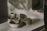 Stylish ceramic tableware set with a play of light and shadows, creating an artistic ambiance.